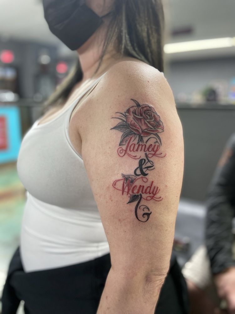 A woman has a tattoo of james and wendy on her arm