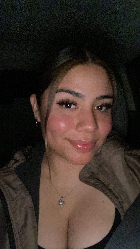 A close up of a woman taking a selfie in a car.