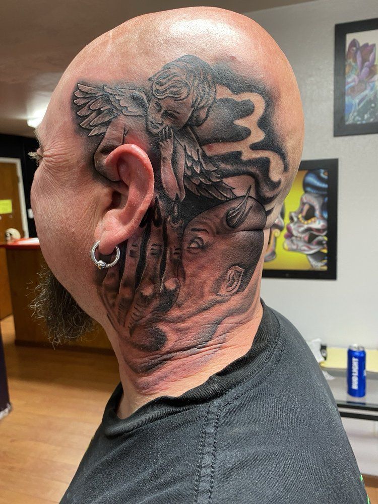 A man with a tattoo on his head and neck