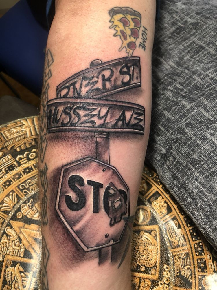 A tattoo of a stop sign on a person 's arm