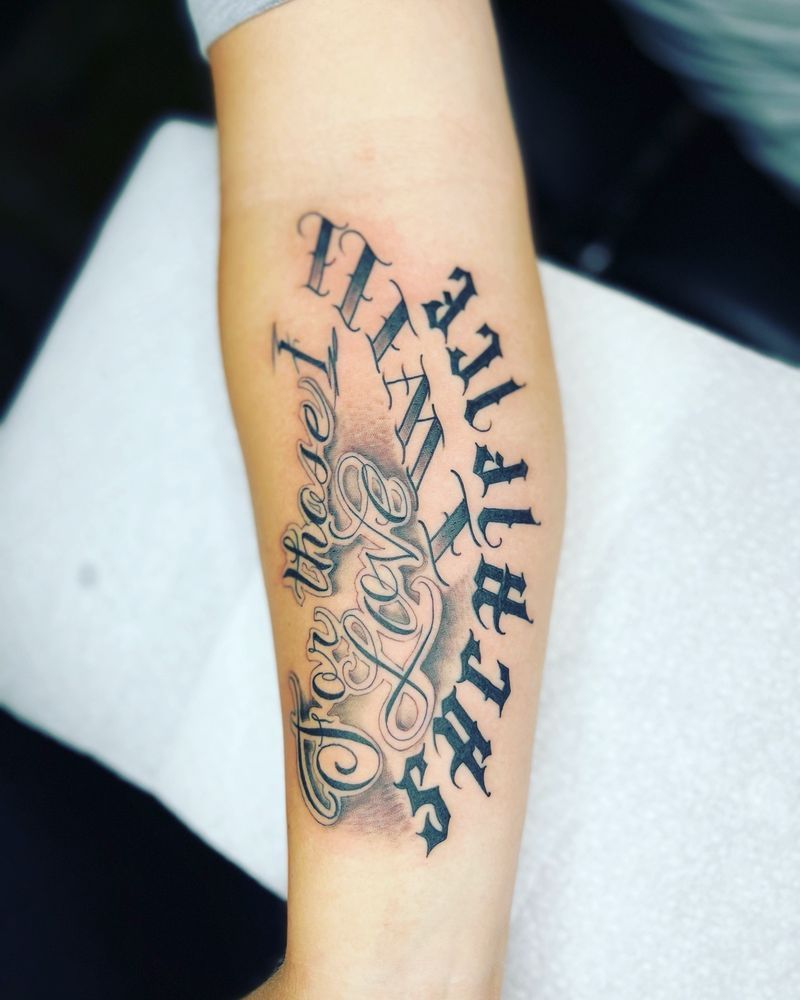 A tattoo on a person 's arm that says 