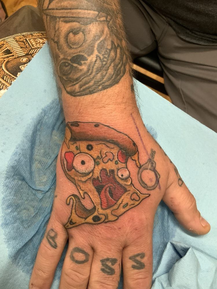 A man has a tattoo of a slice of pizza on his hand