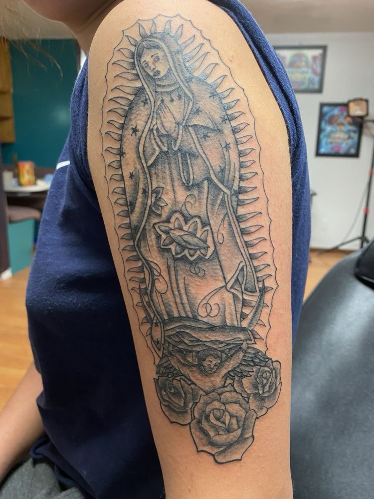 A woman has a virgin mary tattoo on her arm