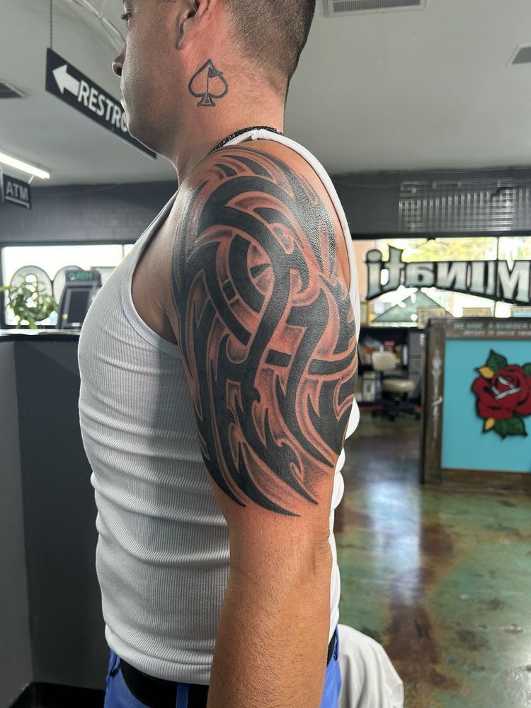 A man with a tribal tattoo on his arm