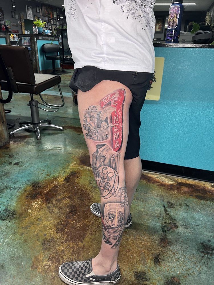 A person with a tattoo on their leg in a tattoo shop.