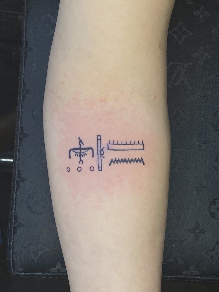 A person has a small tattoo on their forearm