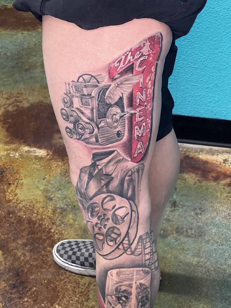 A person has a tattoo on their leg that looks like a car.