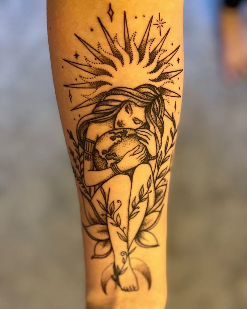 A black and white tattoo of a woman holding a skull