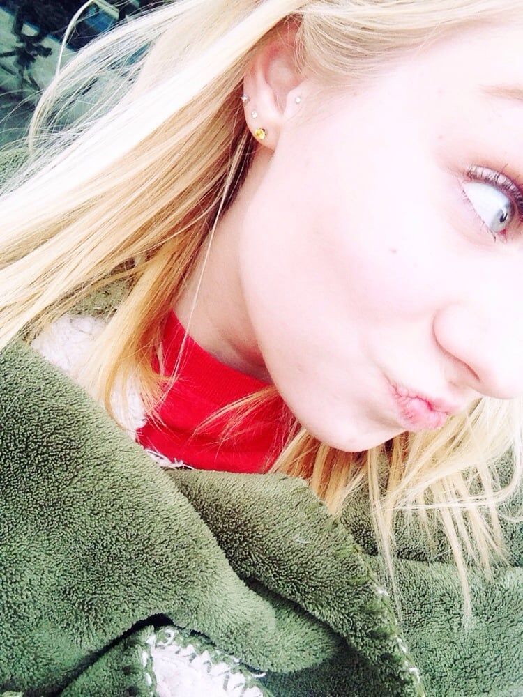 A close up of a woman 's face with a green scarf around her neck