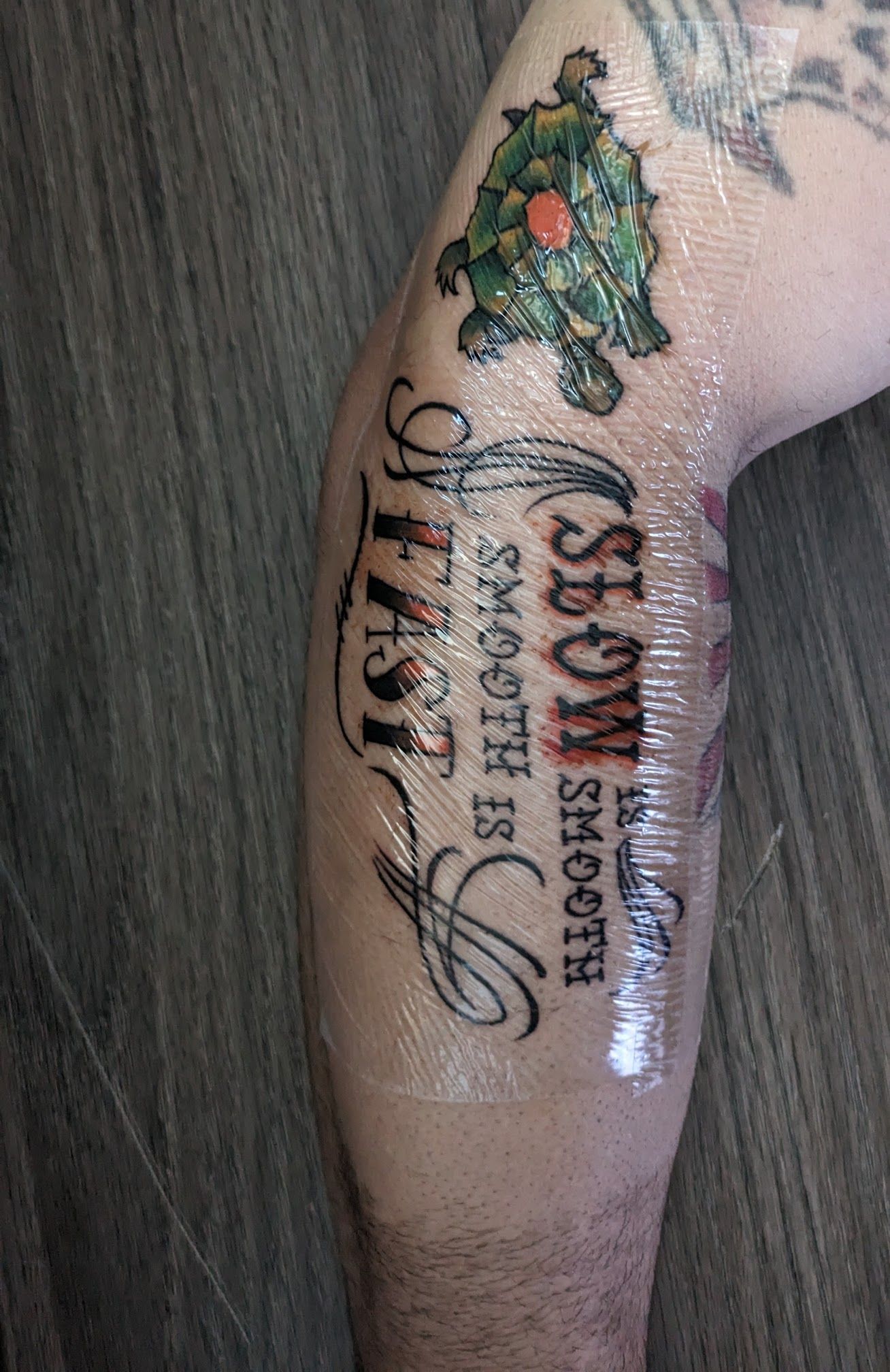 A person has a tattoo on their leg that says `` slow is smooth ''.