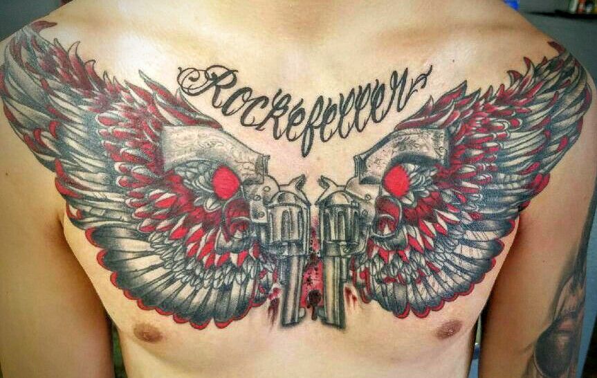 A man has a tattoo on his chest that says rockefeller