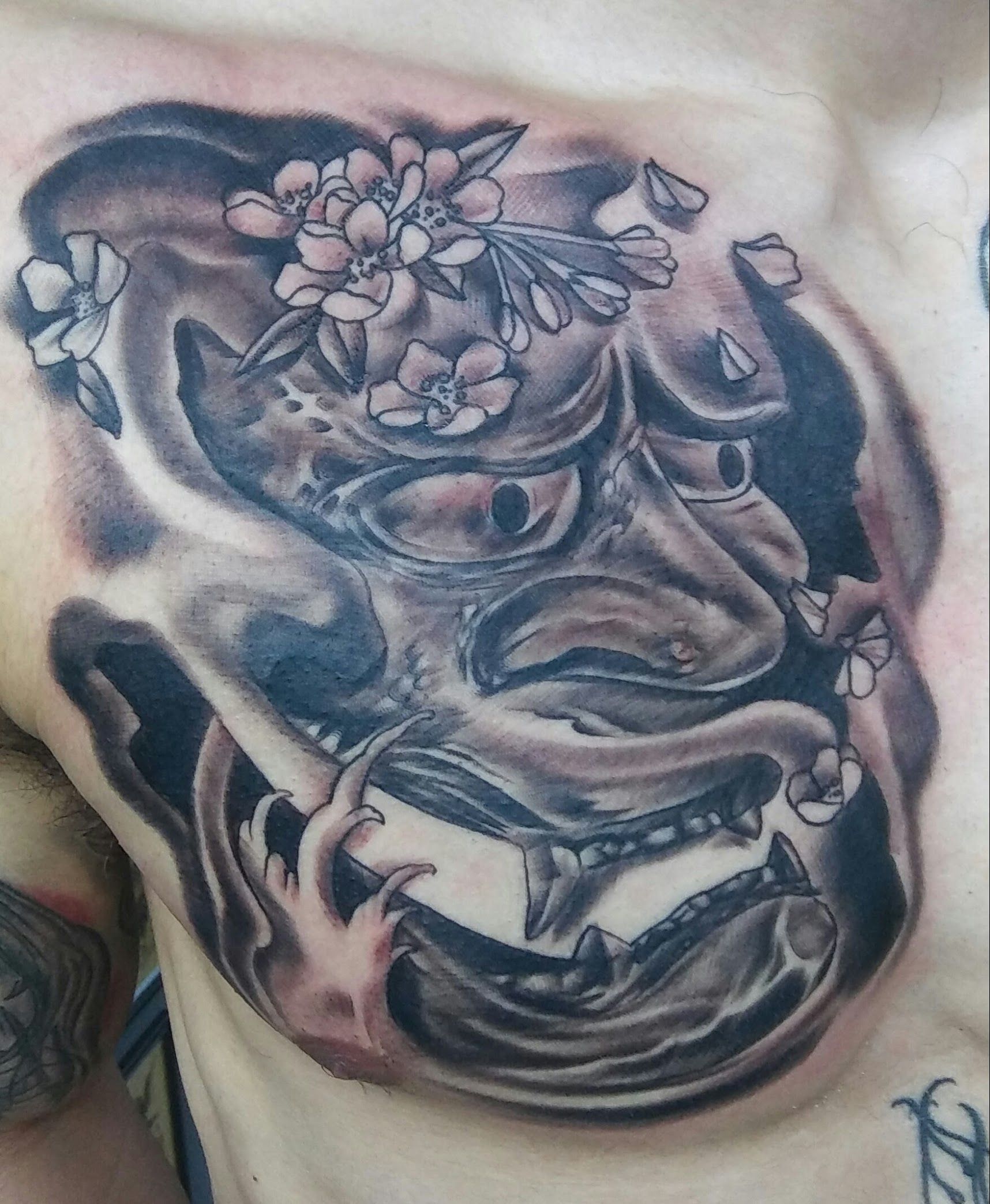 A close up of a tattoo on a man 's chest