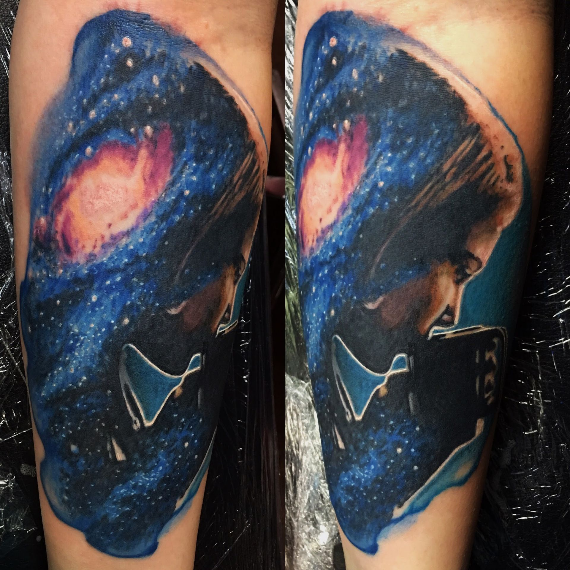 A person has a tattoo of a galaxy on their arm