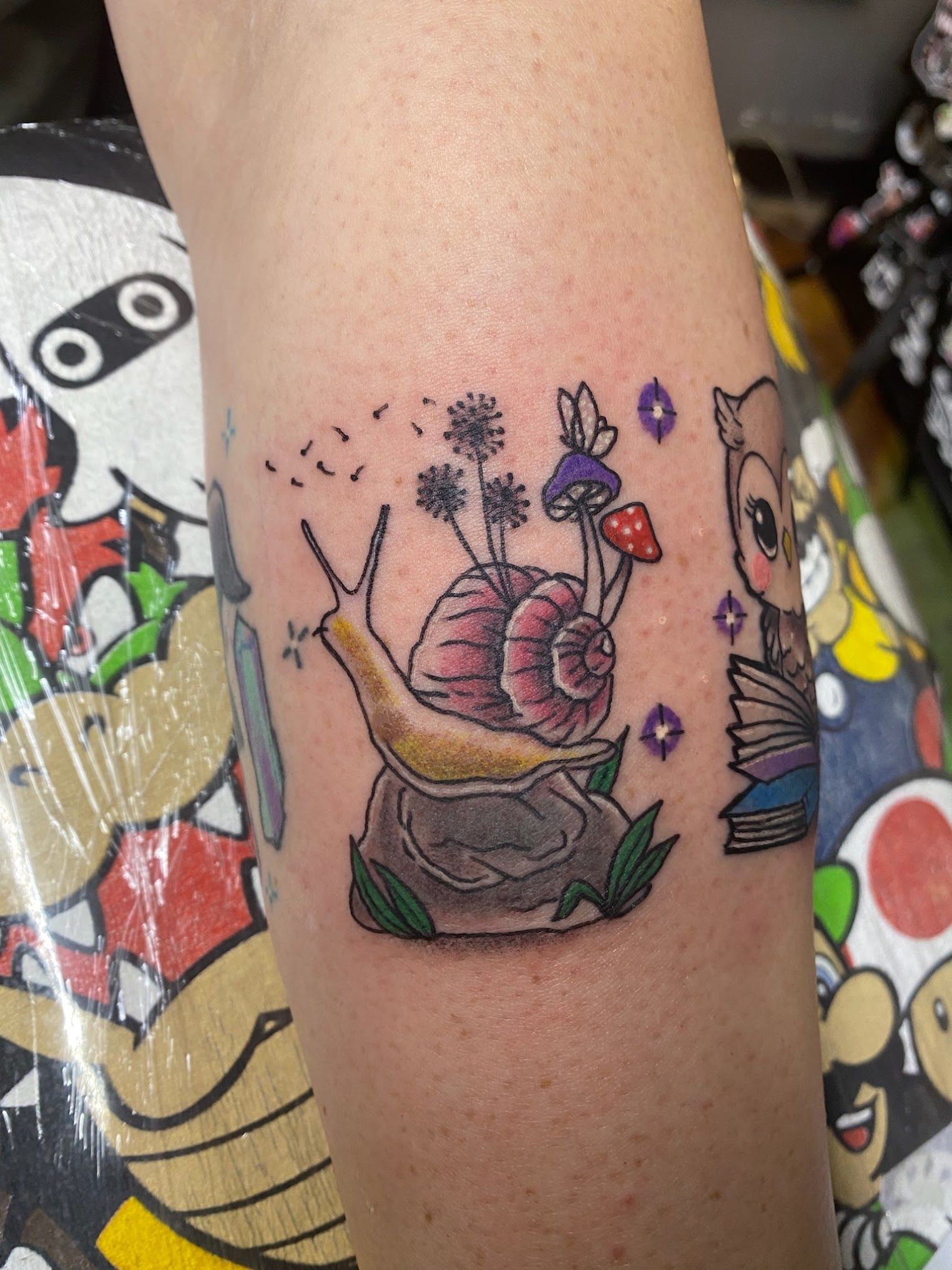 A person has a tattoo of a snail on their arm.