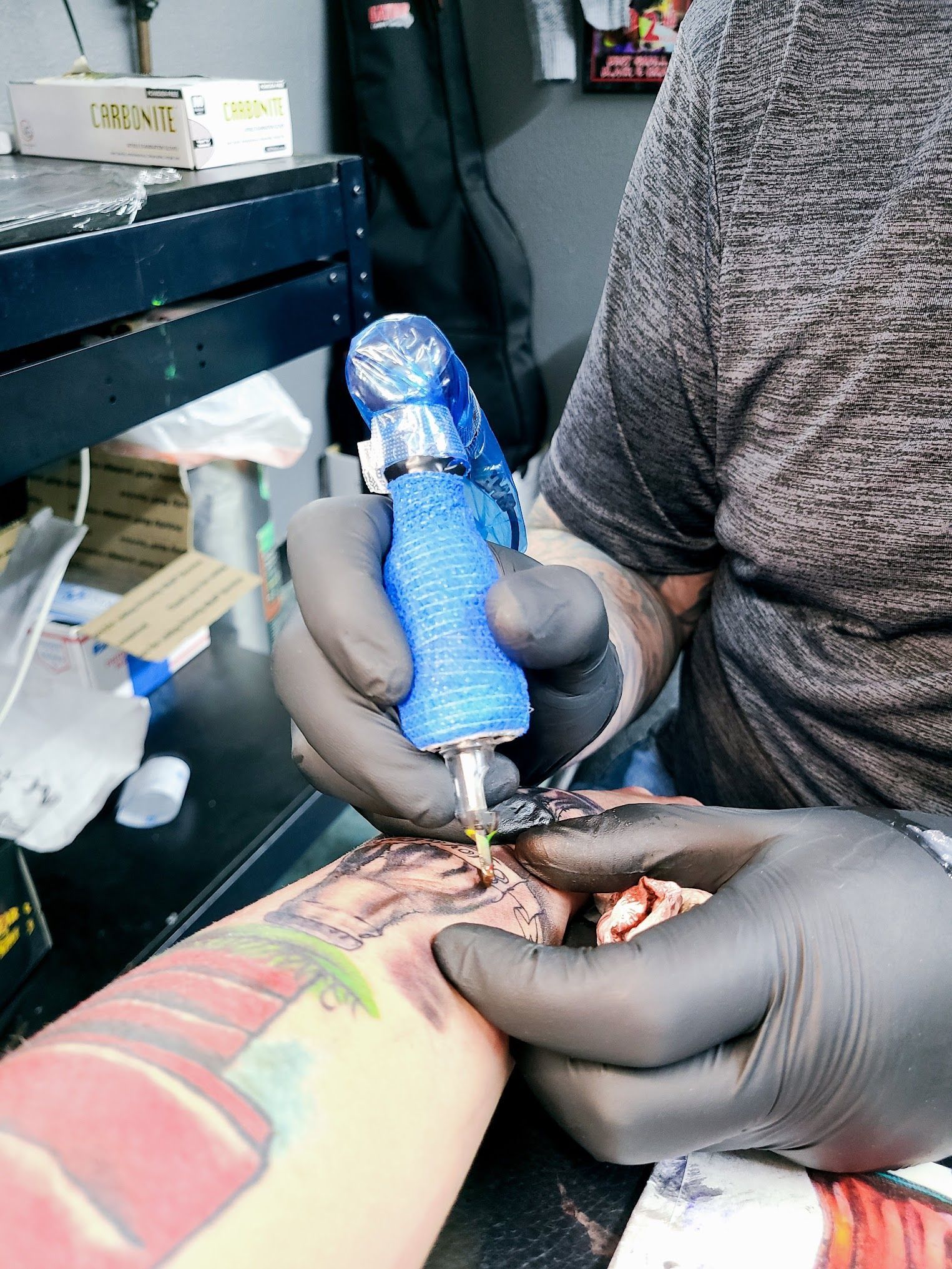 A person is getting a tattoo on their arm.