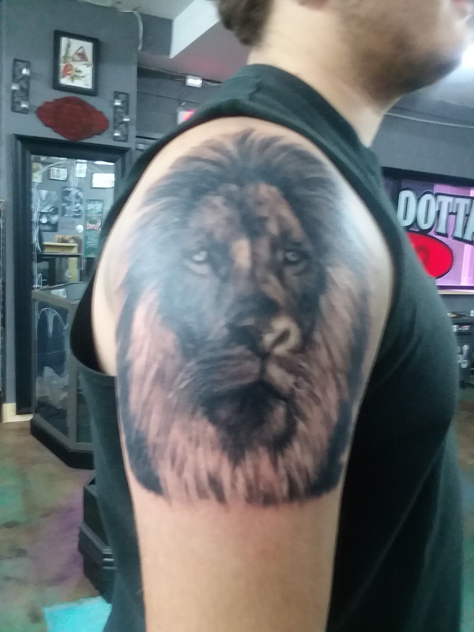 A man has a tattoo of a lion on his arm
