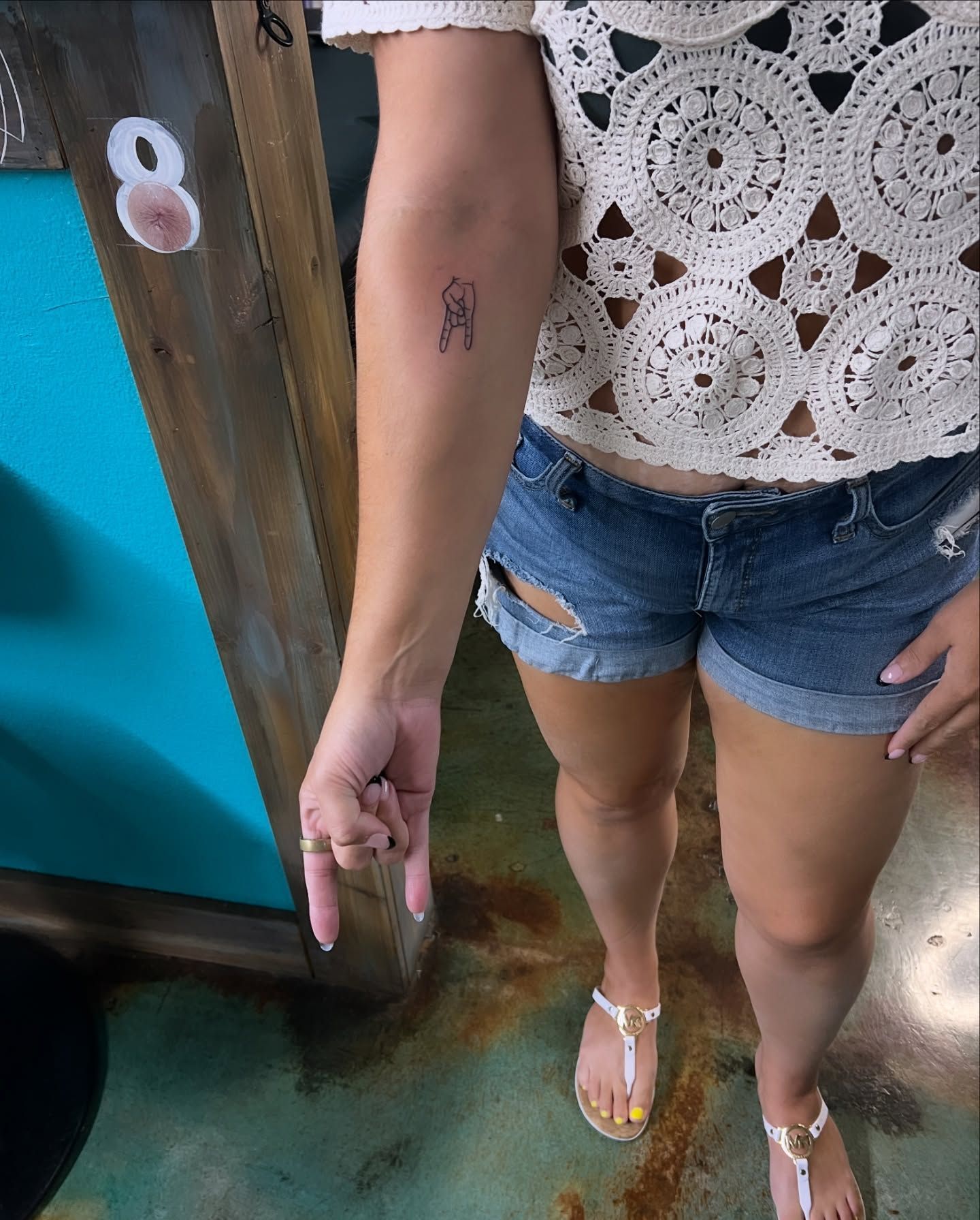 A woman has a small tattoo on her arm.