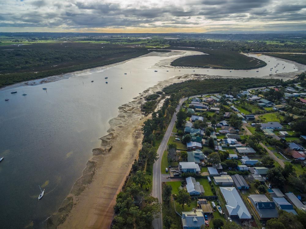 An Aerial View Of A River Surrounded By Houses And Trees — Smith Aluminium In Rutherford, NSW