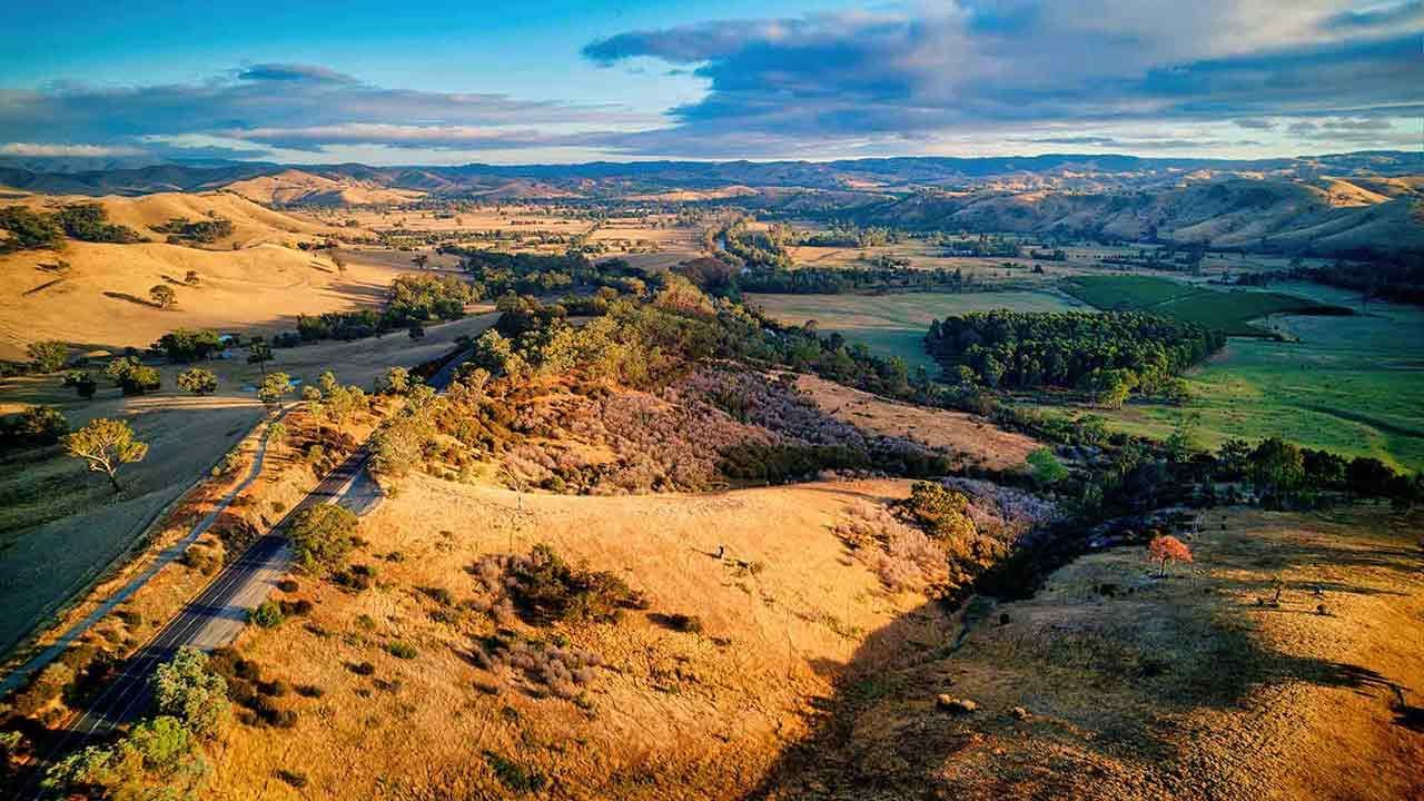 An Aerial View Of A Desert Landscape With A Road Going Through It — Smith Aluminium In Thornton, NSW