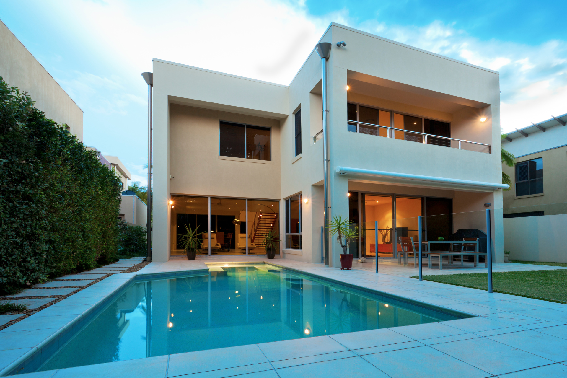 A large house with a swimming pool in front of it