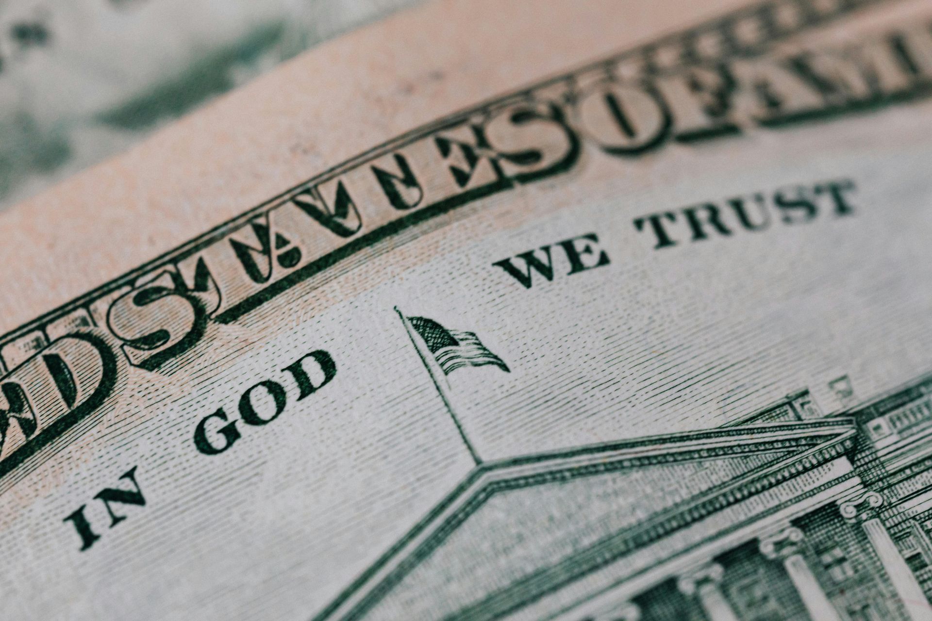A close up of a dollar bill that says in god we trust