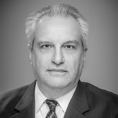 A black and white photo of a man in a suit and tie.