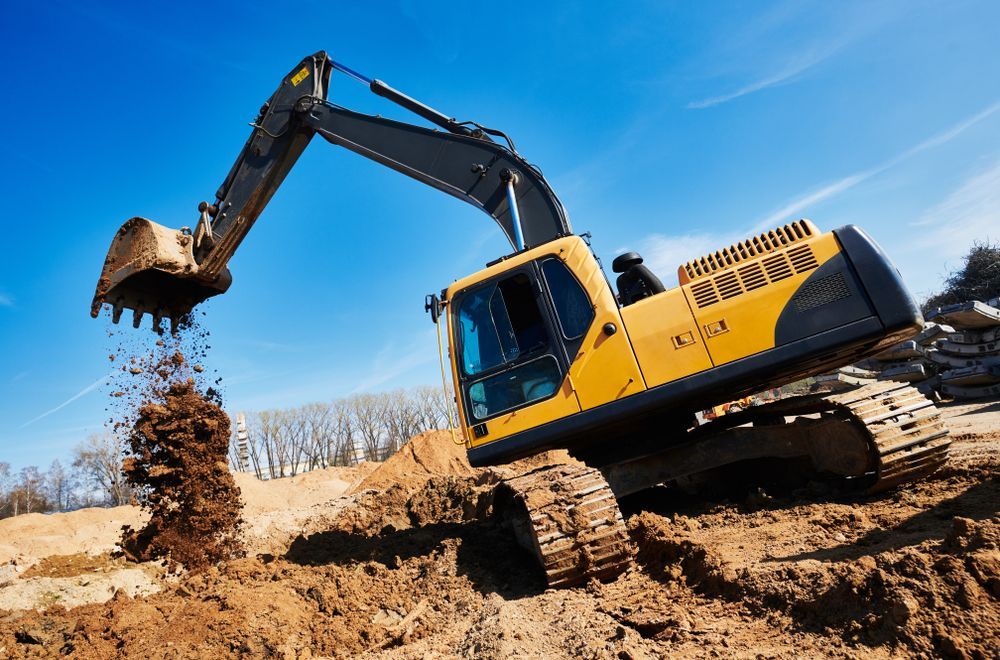 A Yellow Excavator With Its Bucket Raised — GPE Plumbers In Kendall, NSW