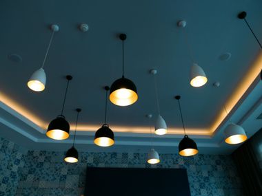 Modern ceiling with hanging pendant lights in a blue-tinted room
