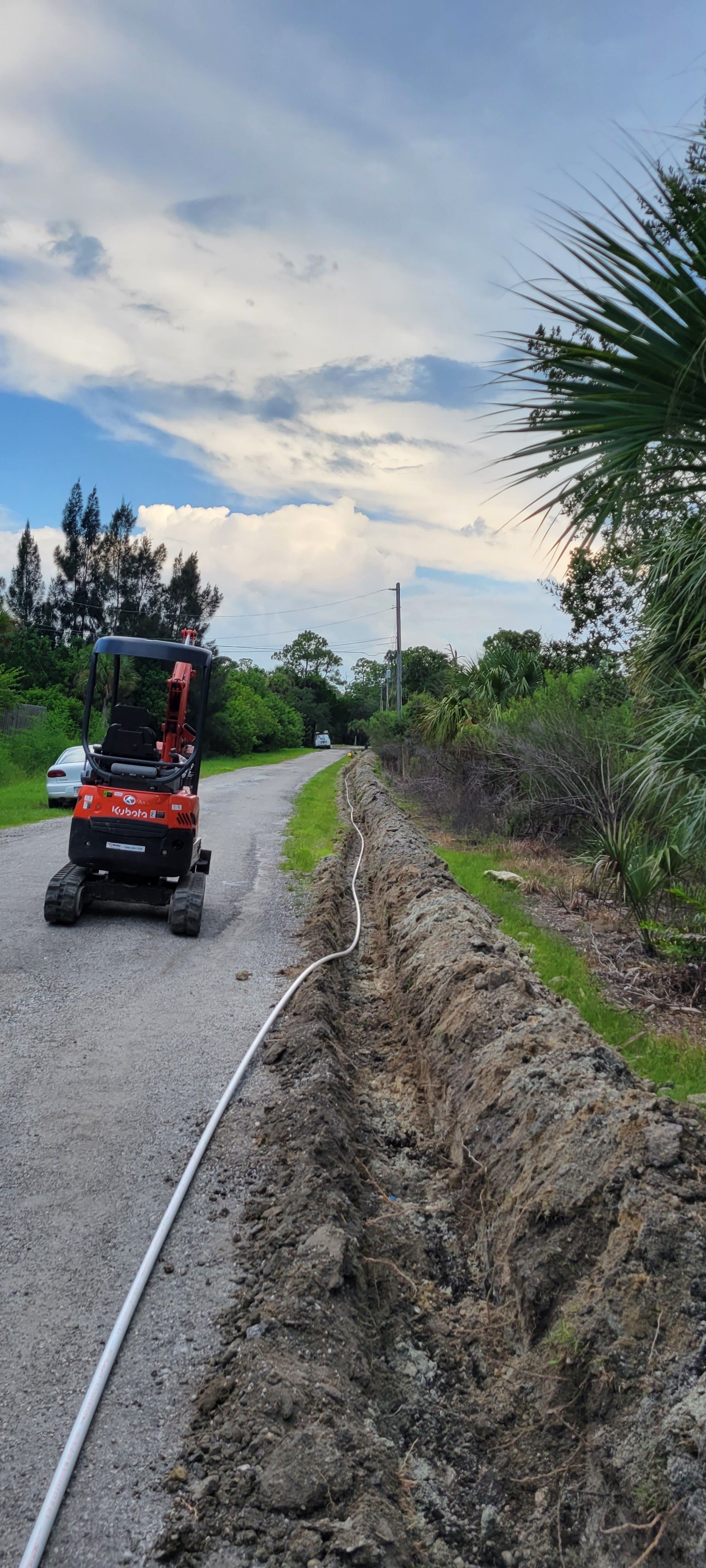 A person is riding a atv down a dirt road.