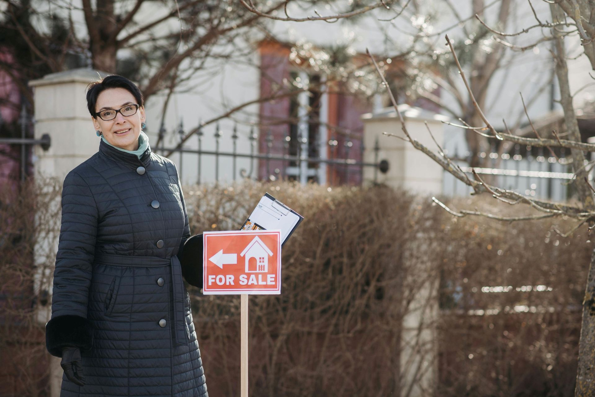 A person in a dark coat holds a small 