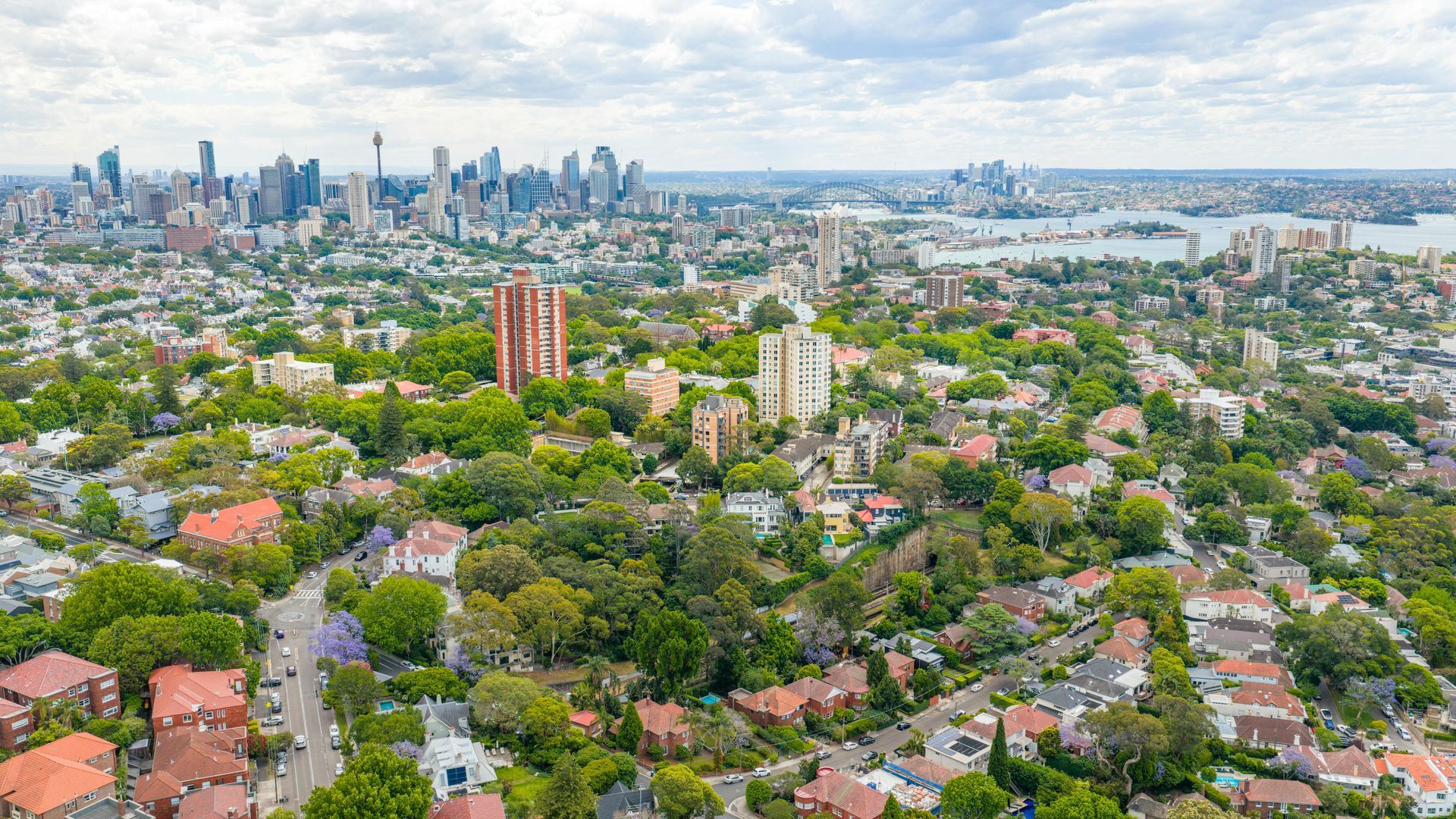 Aerial view of a densely populated coastal city with high-rise buildings.