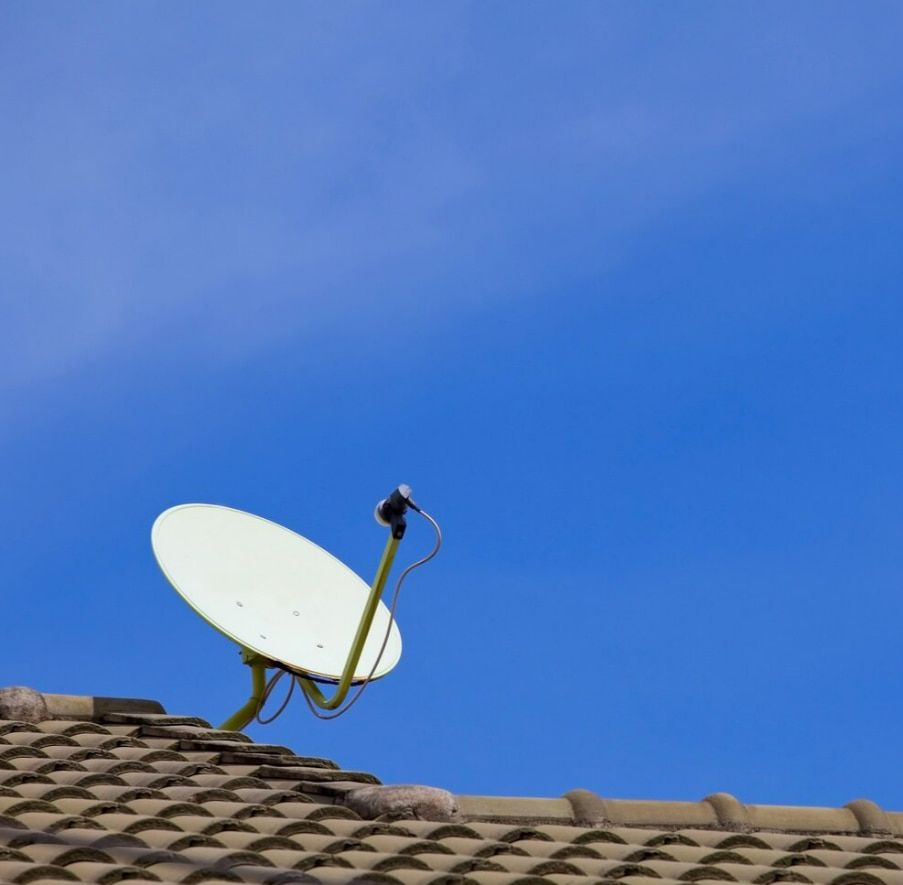 A Satellite Dish Is Sitting On Top Of A Tiled Roof — Outback Internet & Comms In Ciccone, NT