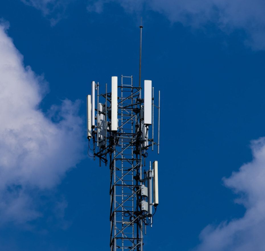 A Cell Phone Tower Against A Blue Sky With Clouds — Outback Internet & Comms In Ciccone, NT