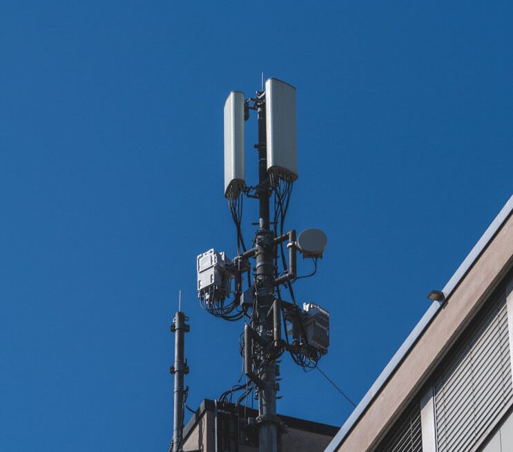 A Cell Phone Tower Is Sitting On Top Of A Building — Outback Internet & Comms In Ciccone, NT
