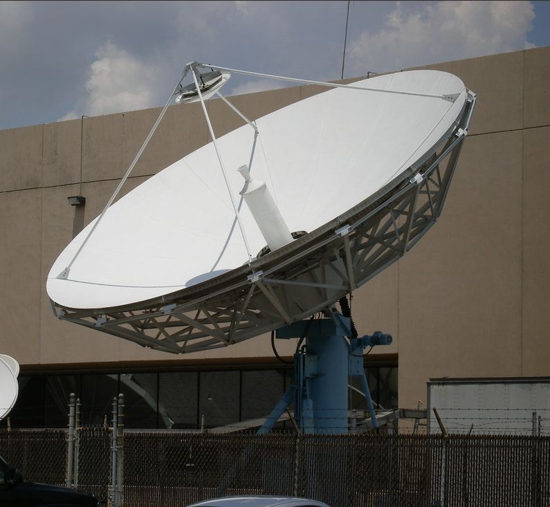 A Large White Satellite Dish Is Sitting In Front Of A Building — Outback Internet & Comms In Ciccone, NT