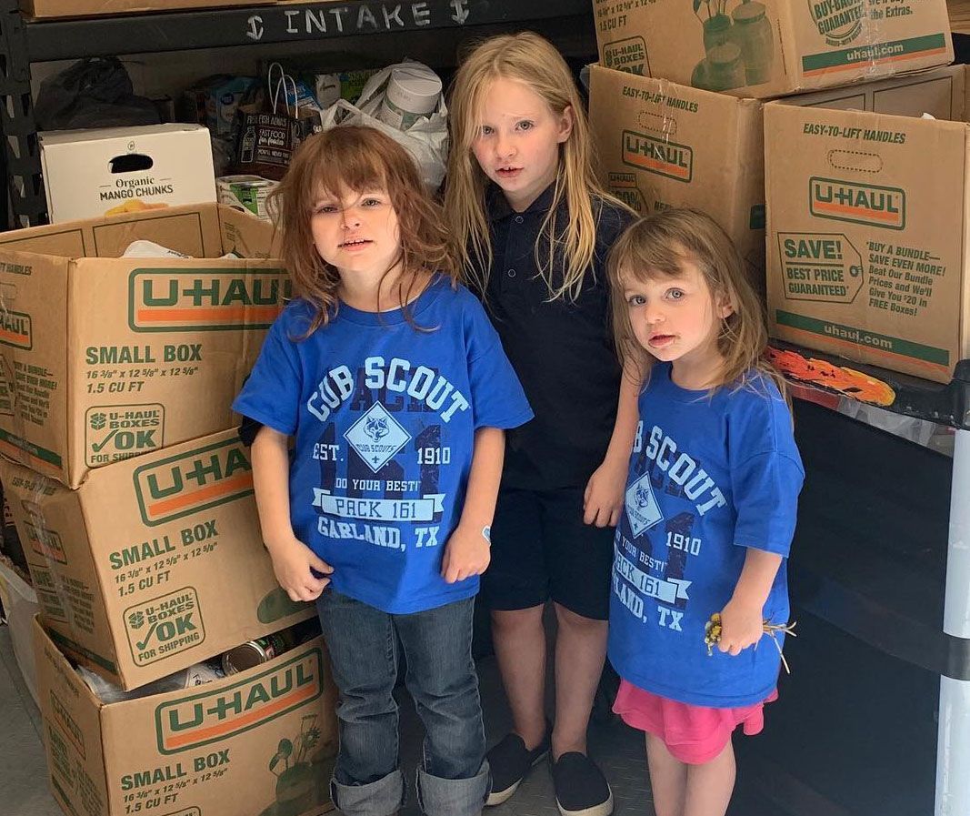 Logo for Good Samaritans of Garland: heart with figure reaching up, text 