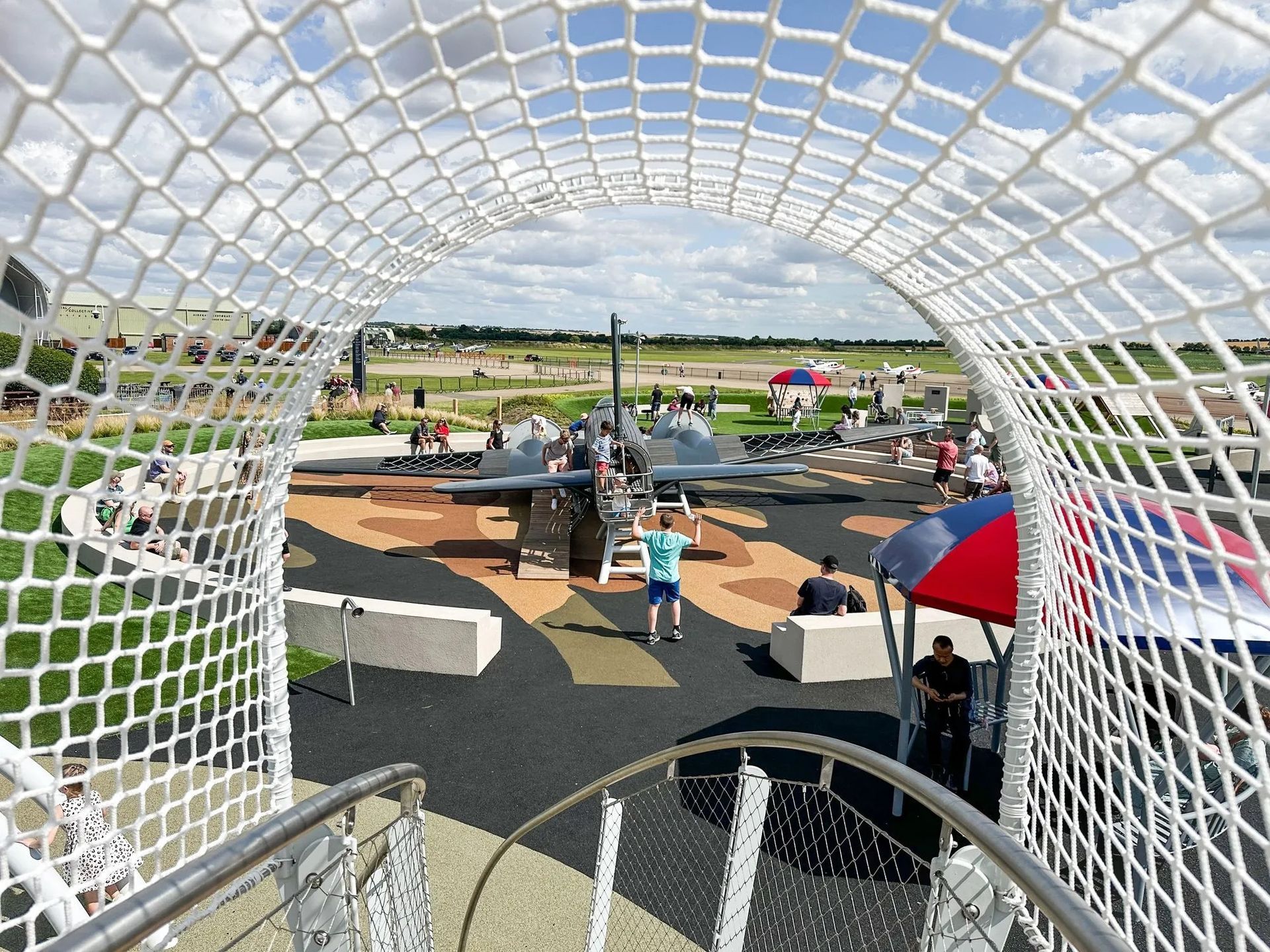 walkway play structure inspired by the con trail left by planes