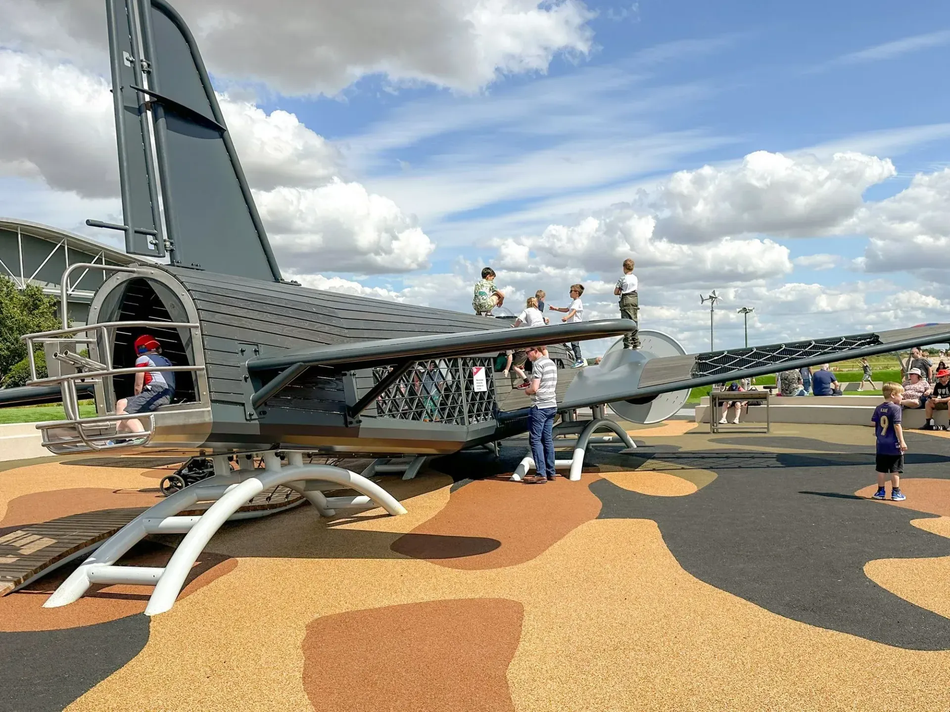 Children playing on Wellington Bomber playful airplane- at IWM Duxford