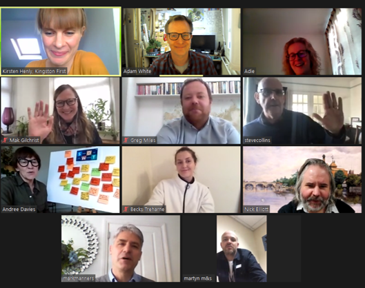 Group video call with eleven people, some waving, smiling. Diverse backgrounds and expressions visible.