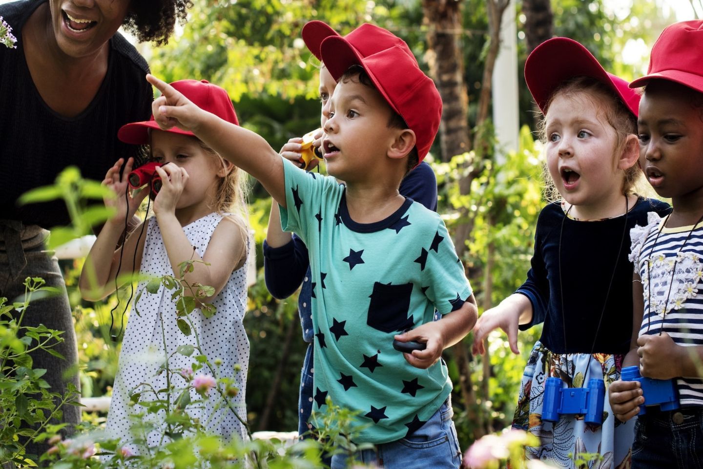 Montessori children exploring nature balancing routines with new experiences.
