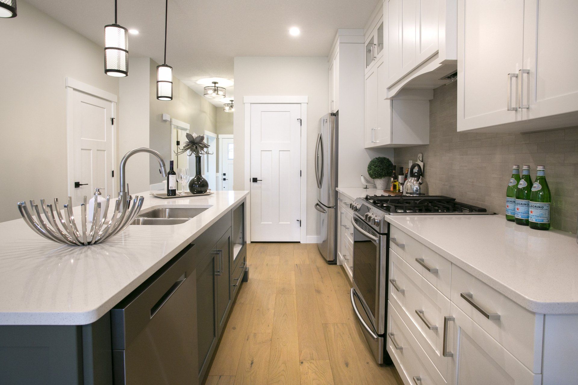 A kitchen with white cabinets and stainless steel appliances.