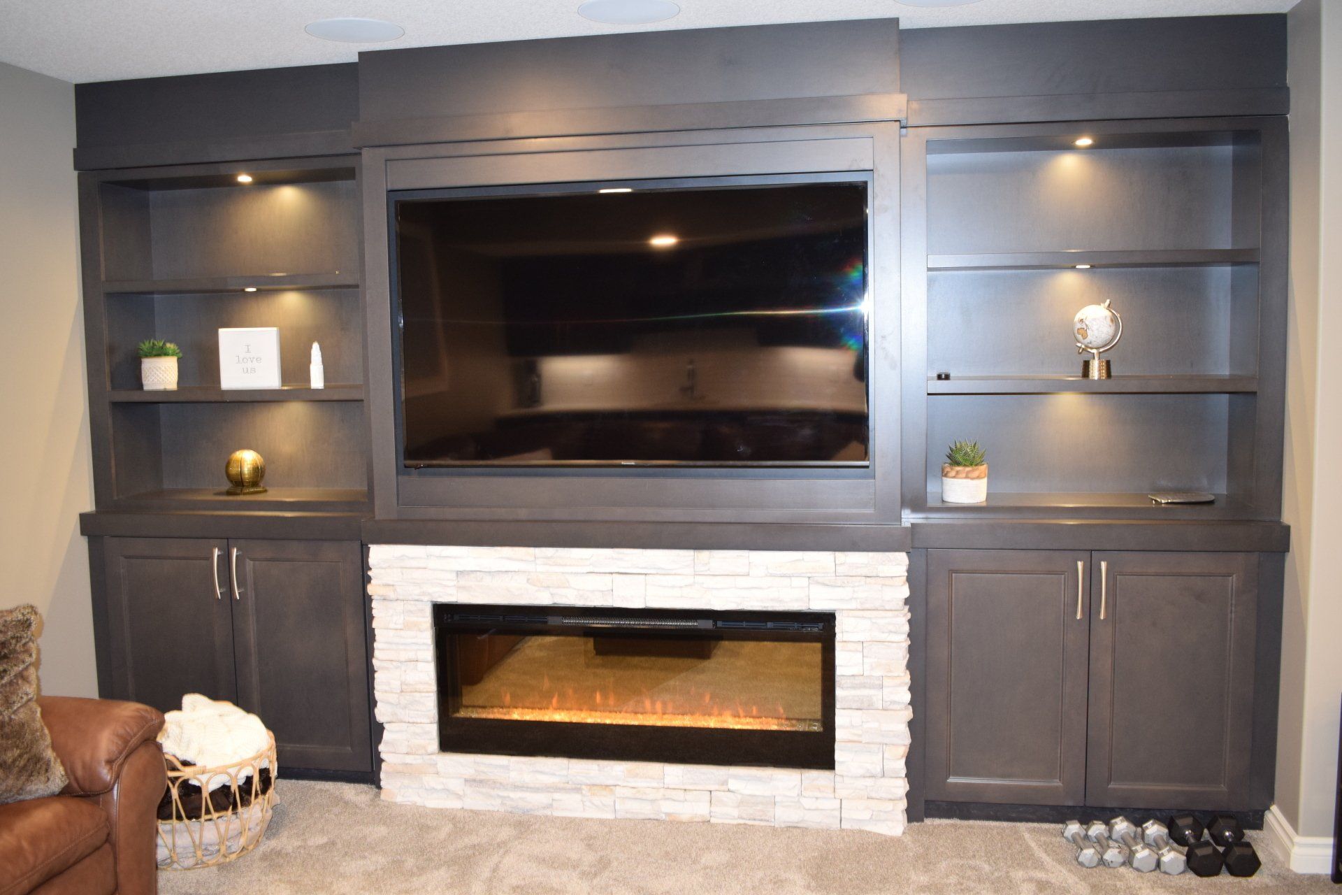 A living room with a fireplace and a flat screen tv