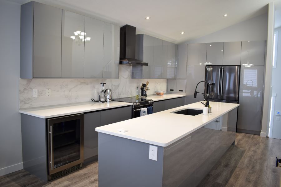 modern kitchen with grey cabinets and white counter top