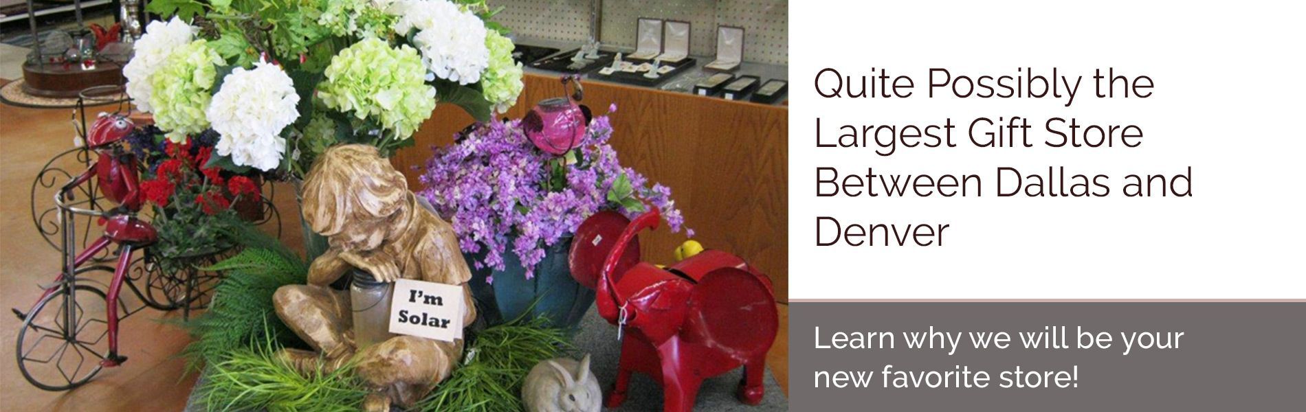 Colorful floral arrangement in a store display with text about the largest gift store between Dallas and Denver