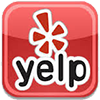 Yelp logo on a red square background with white flower icon and black “yelp” text