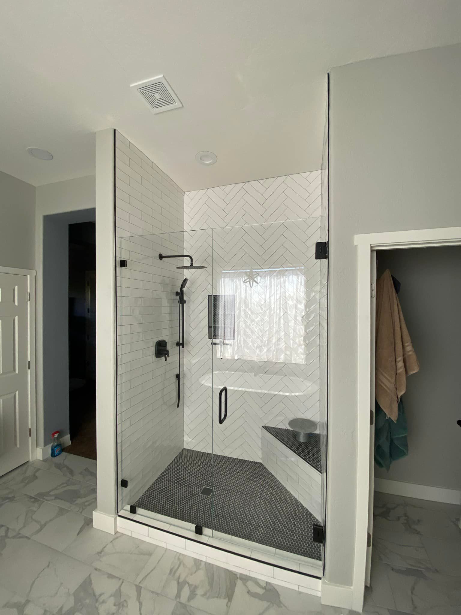 A bathroom with a walk in shower and a bathtub.