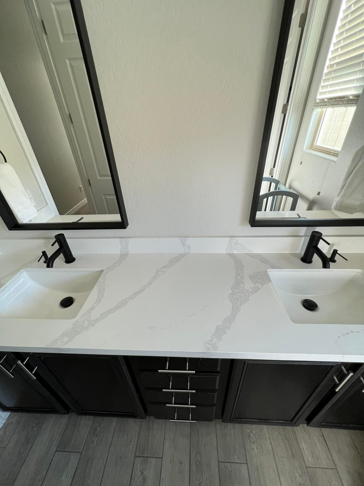 A bathroom with two sinks and two mirrors.