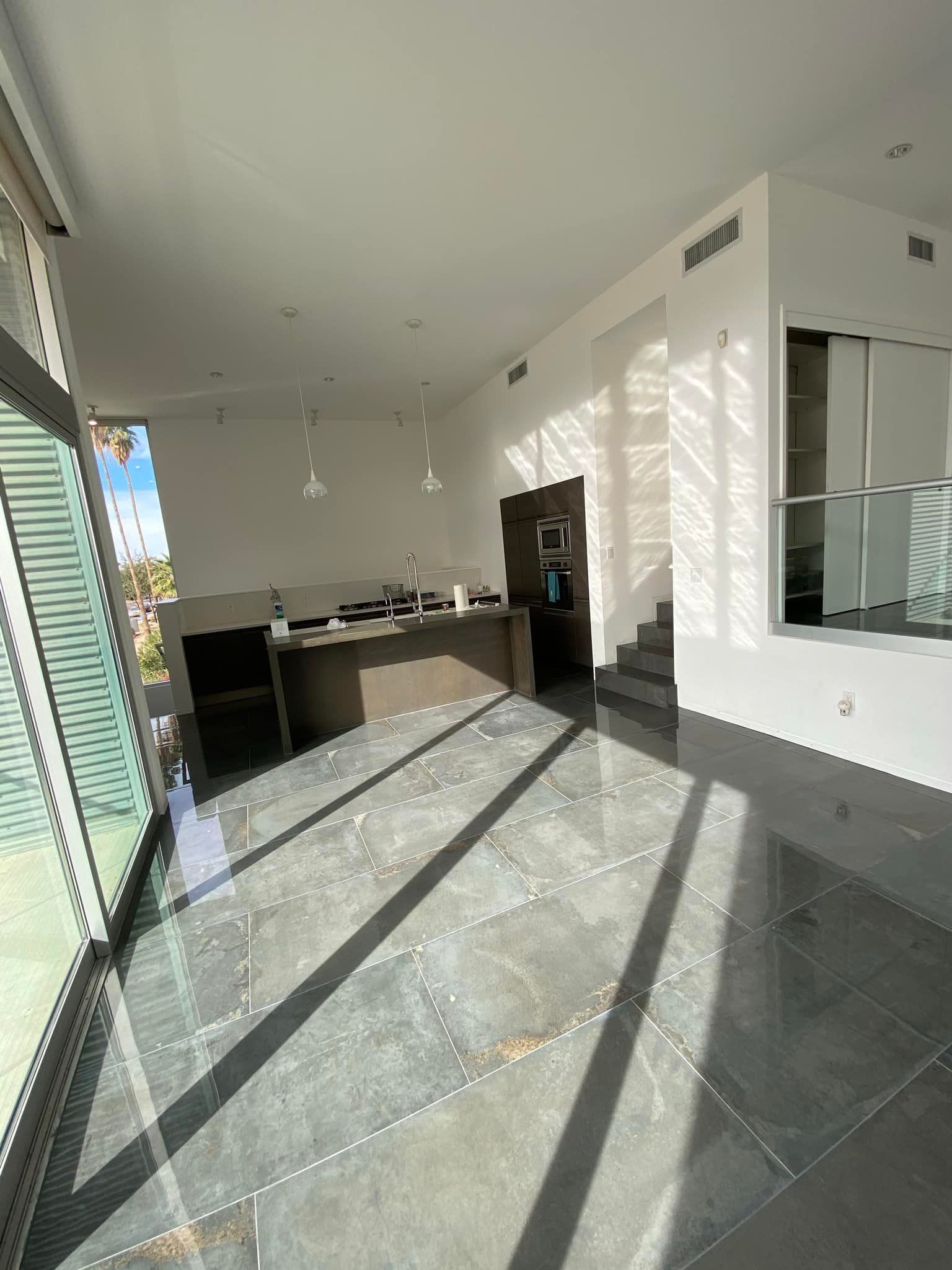 A large room with a lot of windows and a tiled floor.