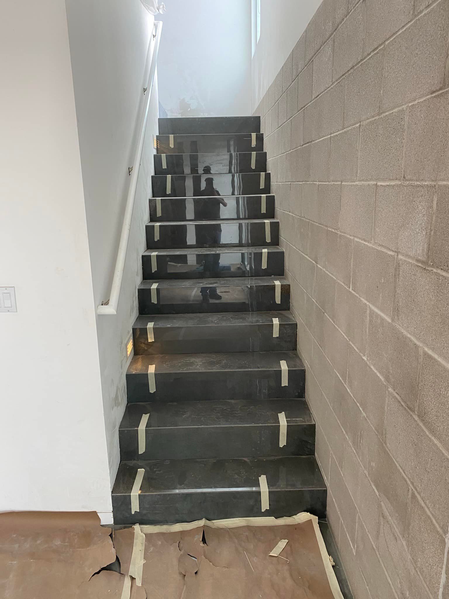 A staircase is being built in a room with a brick wall.
