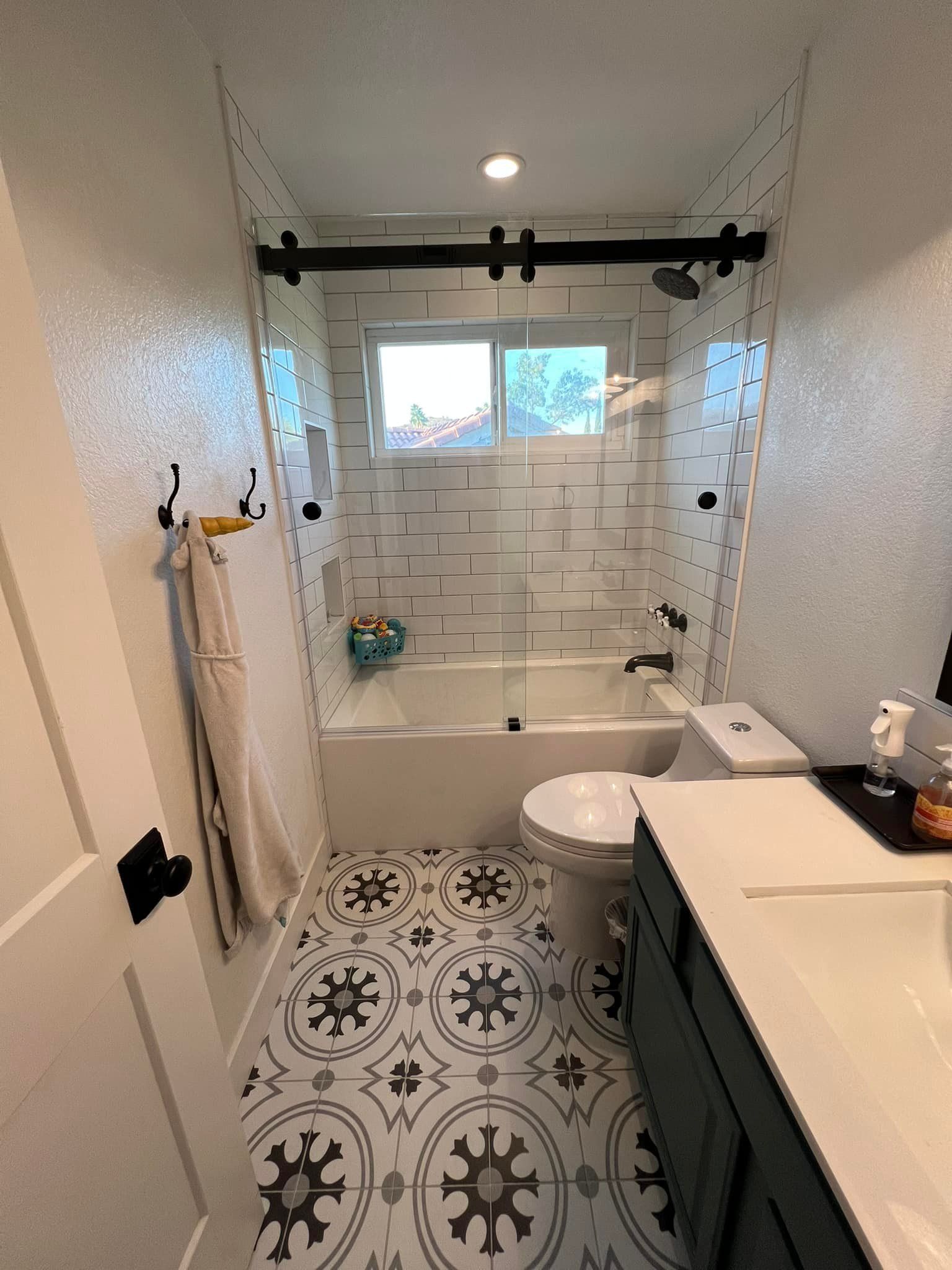 A bathroom with a tub , toilet , sink and shower.